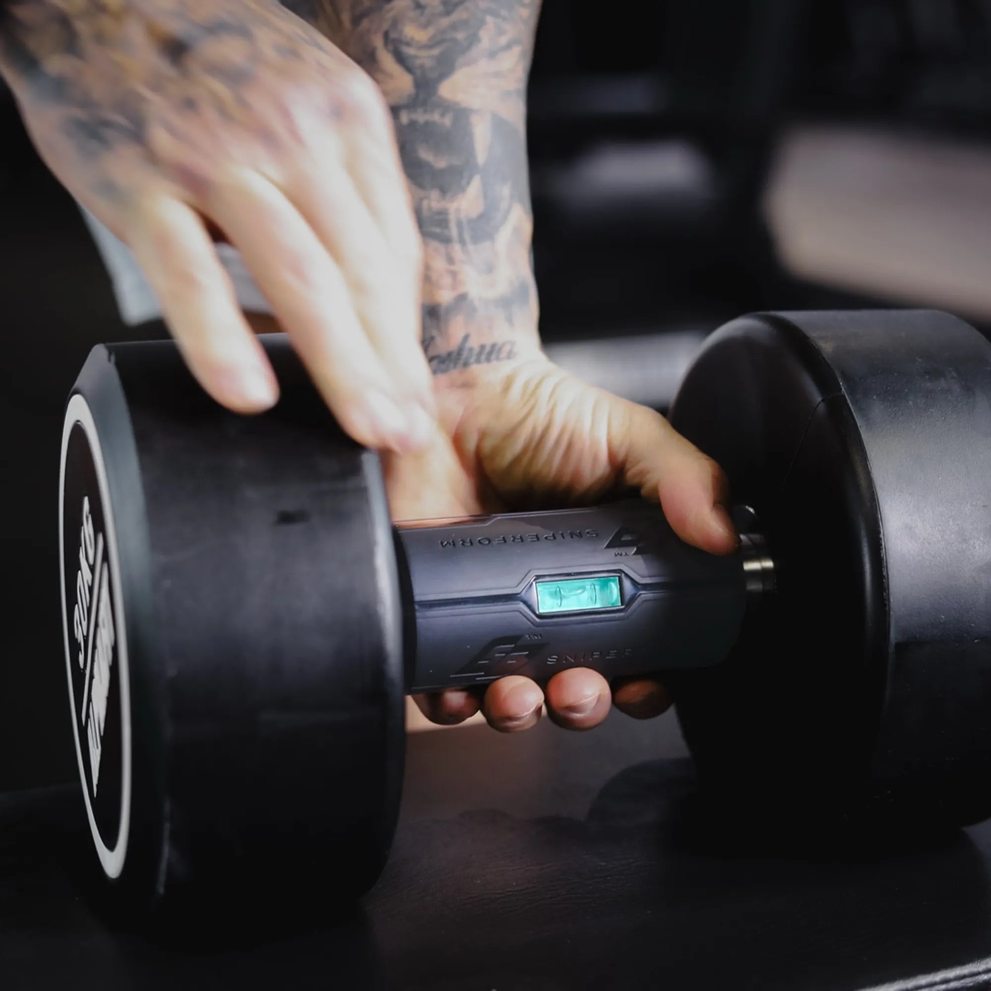 Sniperform LevelUp grip clamped onto a dumbbell handle