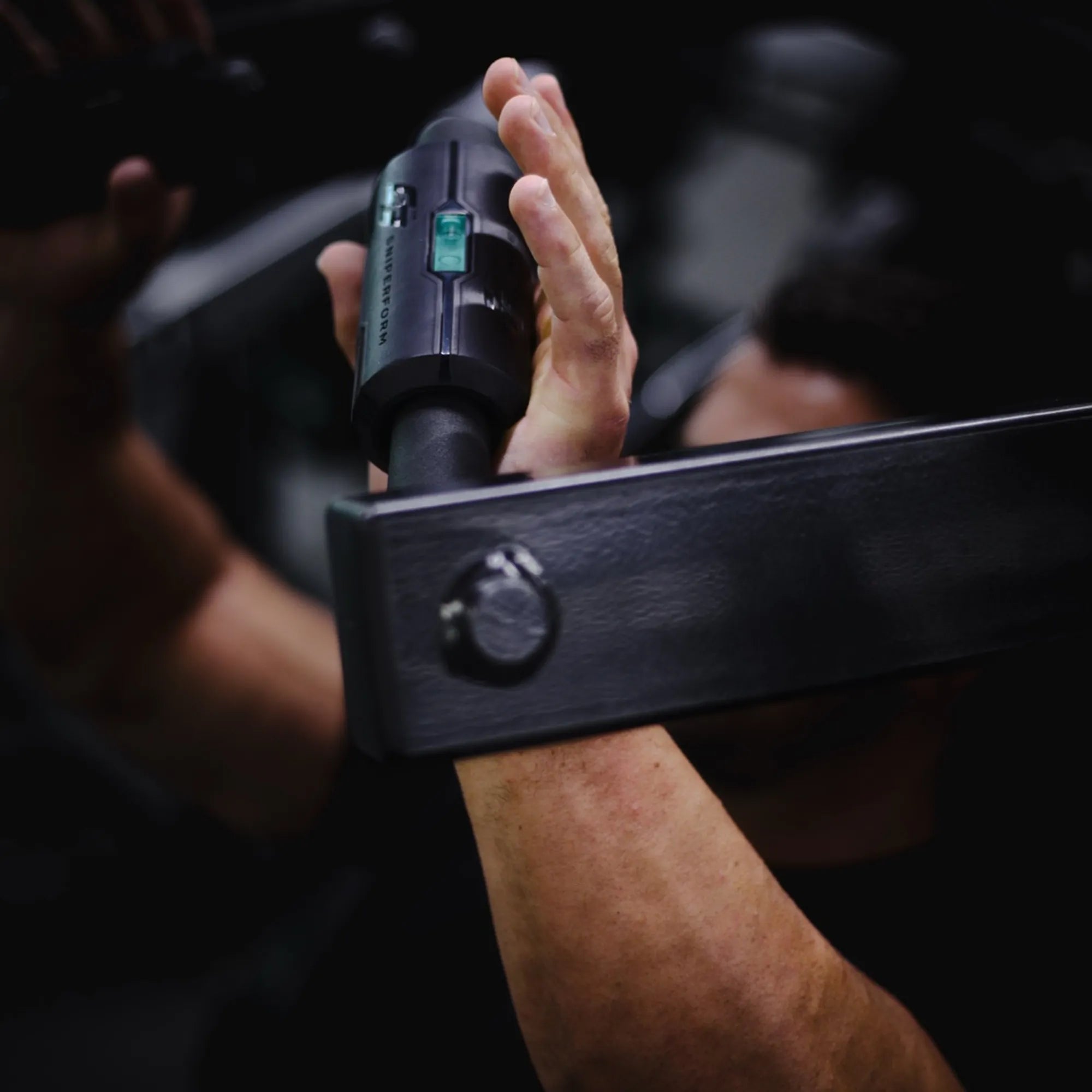 Sniperform LevelUp grip with teal bubble level visible on a barbell